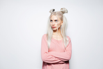 Studio portrait of blonde pretty girl making funny pouting face on white.