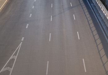 Asphalt road with dividing lines. Top view highway background.