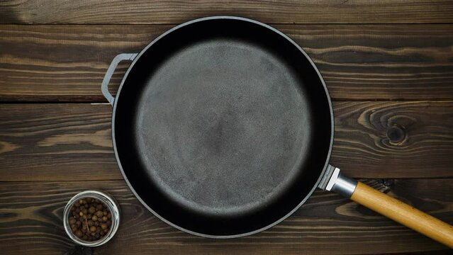 Cast iron pan for frying meat. A professional chef prepares to cooking meat in a skillet. peppercorns, mustard, cumin, red hot chili peppers and spices for marinating. Top view. Copy space for text