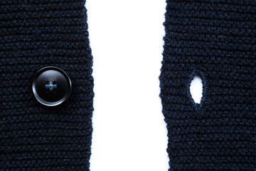 button and buttonhole of blue wool sweater