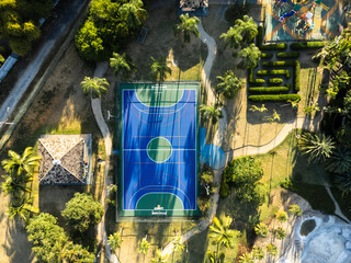 Aerial view of blue multi-sport court in the park. Used to practice football, basketball or...