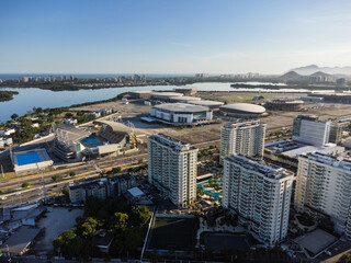 Aerial view of Jacarépagua lagoon in Rio de Janeiro, Brazil. Residential buildings and mountains around the lake. Barra da Tijuca beach in the background. Sunny day. Sunset. Drone photo