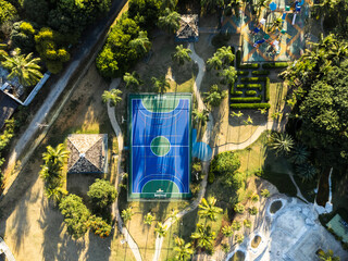 Aerial view of blue multi-sport court in the park. Used to practice football, basketball or...