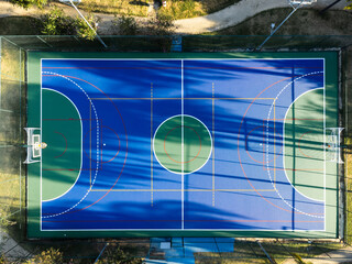 Aerial view of blue multi-sport court in the park. Used to practice football, basketball or...