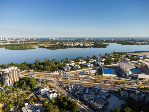 Aerial View Of Jacarépagua Lagoon In Rio De Janeiro, Brazil. Residential Buildings And Mountains Around The Lake. Barra Da Tijuca Beach In The Background. Sunny Day. Sunset. Drone Photo