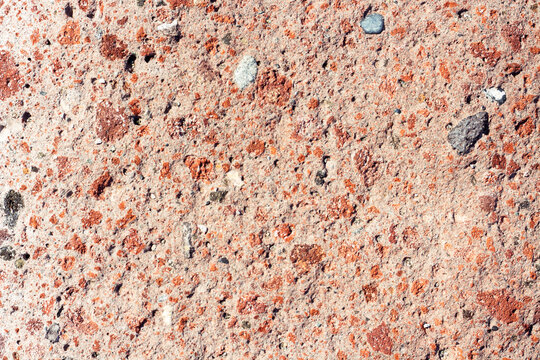 Natural stone textured horizontal background in red colors. 