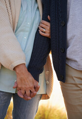 Committed through thick and thin. Cropped view of a senior couple holding hands.