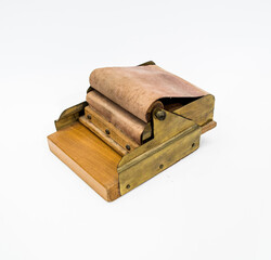 old cigarette rolling machine on white background
