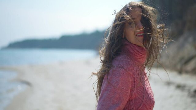 Frightened scared Caucasian woman running on sandy beach looking back. Live camera follows anxious lady escaping in slow motion with worried facial expression. Fears and scare concept