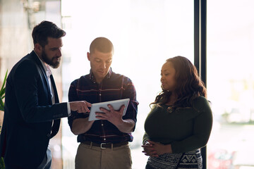 We can make a few changes here. Shot of a focused group of businesspeople having a discussion while...