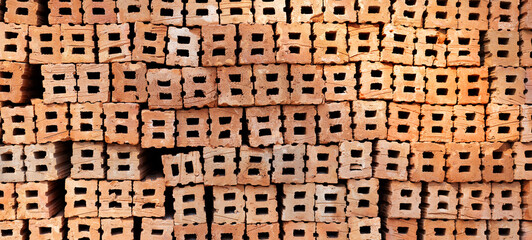 Stack of red bricks, orange clay bricks