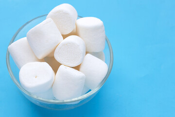 Delicious white marshmallows on blue background.