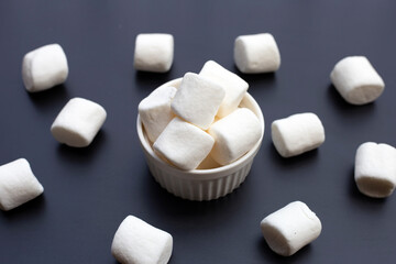 Delicious fluffy round marshmallows, White candy on dark background.