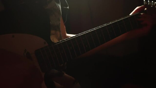 Persona tocando la guitarra a contraluz. Concepto de musica.