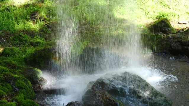 A waterfall that hits a rock.