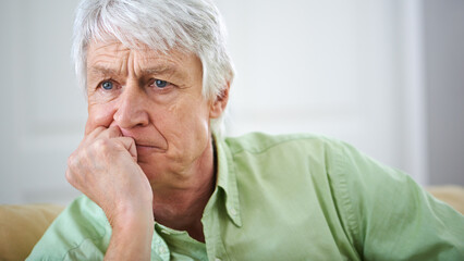 Somethings got to give.... Shot of an elderly man deep in thought at home.