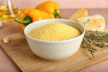 Bowl of raw couscous on table
