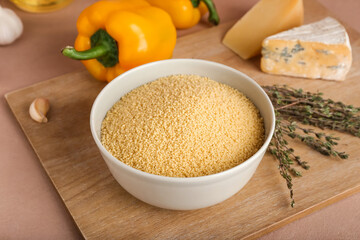 Bowl of raw couscous on table