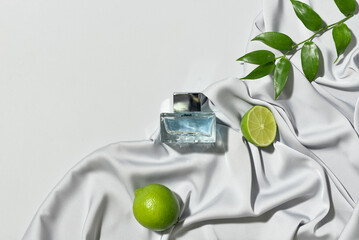 Bottle of fresh perfume on light background, top view