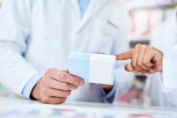 Teamwork makes the treatment work. Cropped shot of a man and woman discussing medication while working at a pharmacy.