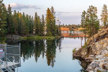 Fototapeta premium A portion of the Spokane River near the Avista Dam at Falls Park in Post Falls, Idaho, USA, with a small marina in the distance.