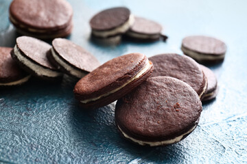 Delicious chocolate cookies with cream on dark background, closeup