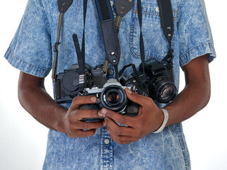 He has a photographers eye. Studio shot of an unrecognizable photographer with a collection of cameras.
