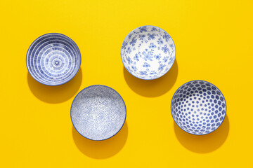 Chinese bowls on color background