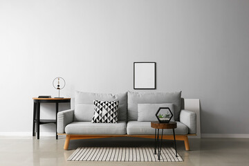 Interior of modern living room with stylish sofa, table and photo frame