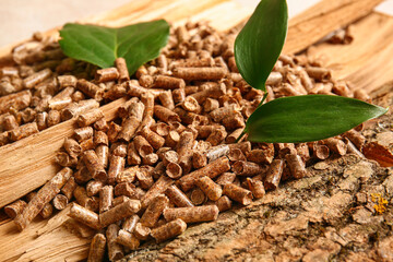Pile of wood pellets and green leaves, closeup