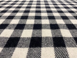 Obraz premium Black and white tartan square background. Black and white fabric. Close-up gingham fabric background. Plaid.