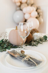 Decoration in boho style. Pumpkins on the table with eucalyptus and gypsophila. Stylish table decoration for the event.