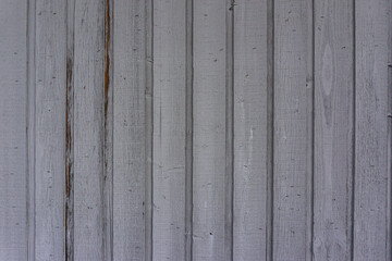 White and brown wall decaying wood vertical lines with an old paint job.