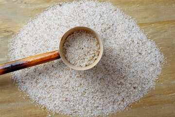 portion of raw psyllium husk over rustic wooden table
