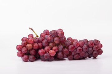 Red grapes photographed in a studio on a white background.