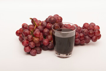 Red grapes photographed in a studio on a white background.