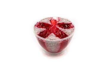 Pink jelly body scrub with strawberry scent on a white background.