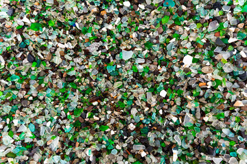 Glass Bay in Vladivostok. Sea-polished colored glass on the beach. Background, texture