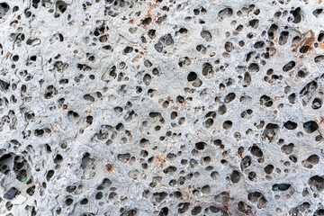 texture of porous stones on the beach, nature, natural phenomena, brown gray stones