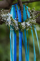 Head wreath with blue ribbons and fresh flowers