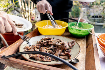 Fresh sliced carne asada being served