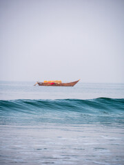 Arabian Sea waves with Empty Fisherman boat in background