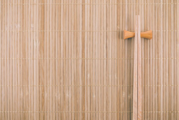 Empty Japanese chopsticks on bamboo mat background. Japanese food, sushi, omakase concept.