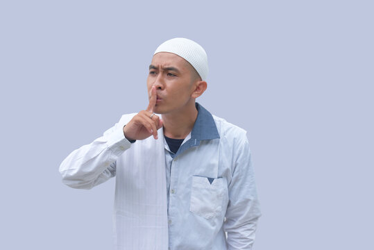 portrait of muslim man with silent gesture