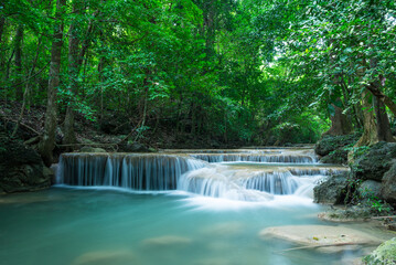 Beautiful Erawan tropical waterfall in Kanchanaburi province, Thailand. Travel tropical forest concept.