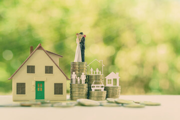 Sustainable financial goal for family life or married life concept : Miniature wedding couple,...