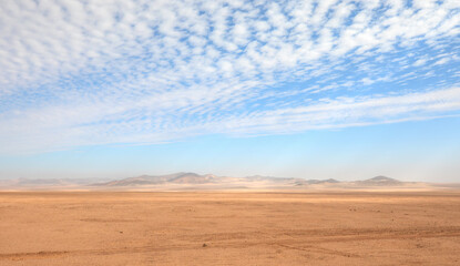Fototapeta na wymiar Panoramic view of desert plains in Namibia Africa with hills and mountains in the background 