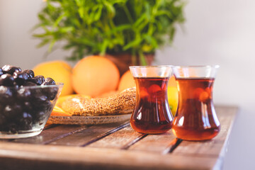 Turkish tea, oranges and olives on wooden table