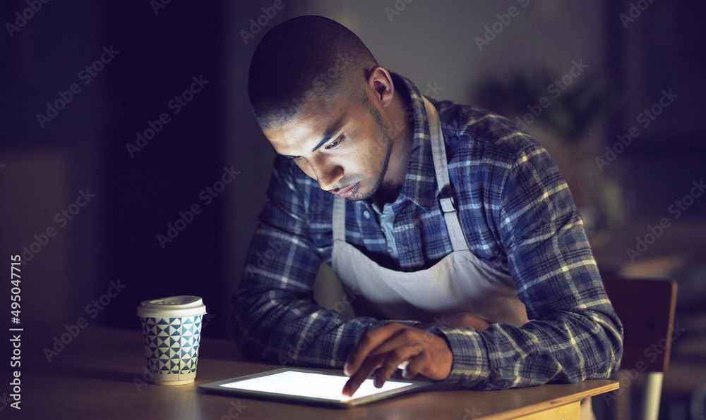 Aufkleber he has the drive to get tasks done at anytime. shot of a young man working late on a digital tablet 