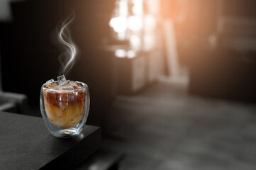 Ice coffee on a table with cream being poured into it showing the texture and refreshing look of the drink